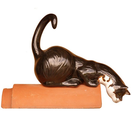 katze lauernd auf einem firstziegel